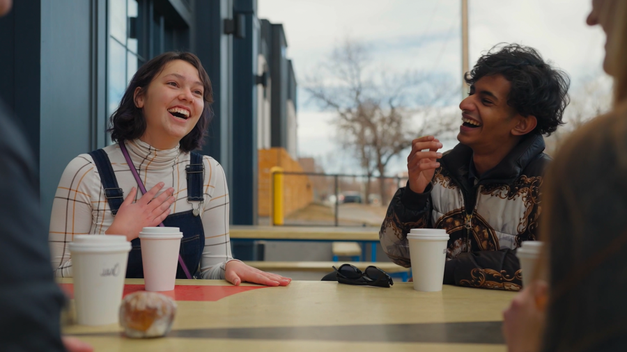 two students laughing over coffee